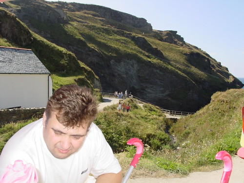 Man in forground with cliffs in backgrround.