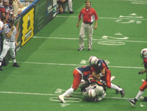 Carlos Smith and (I think) Mike Hanley squish Jay Bailey for a 2-yard loss.
