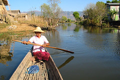 woman rows in a small boat / Inle Lake