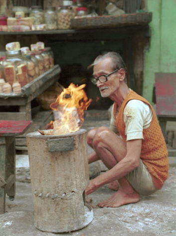 old man making fire